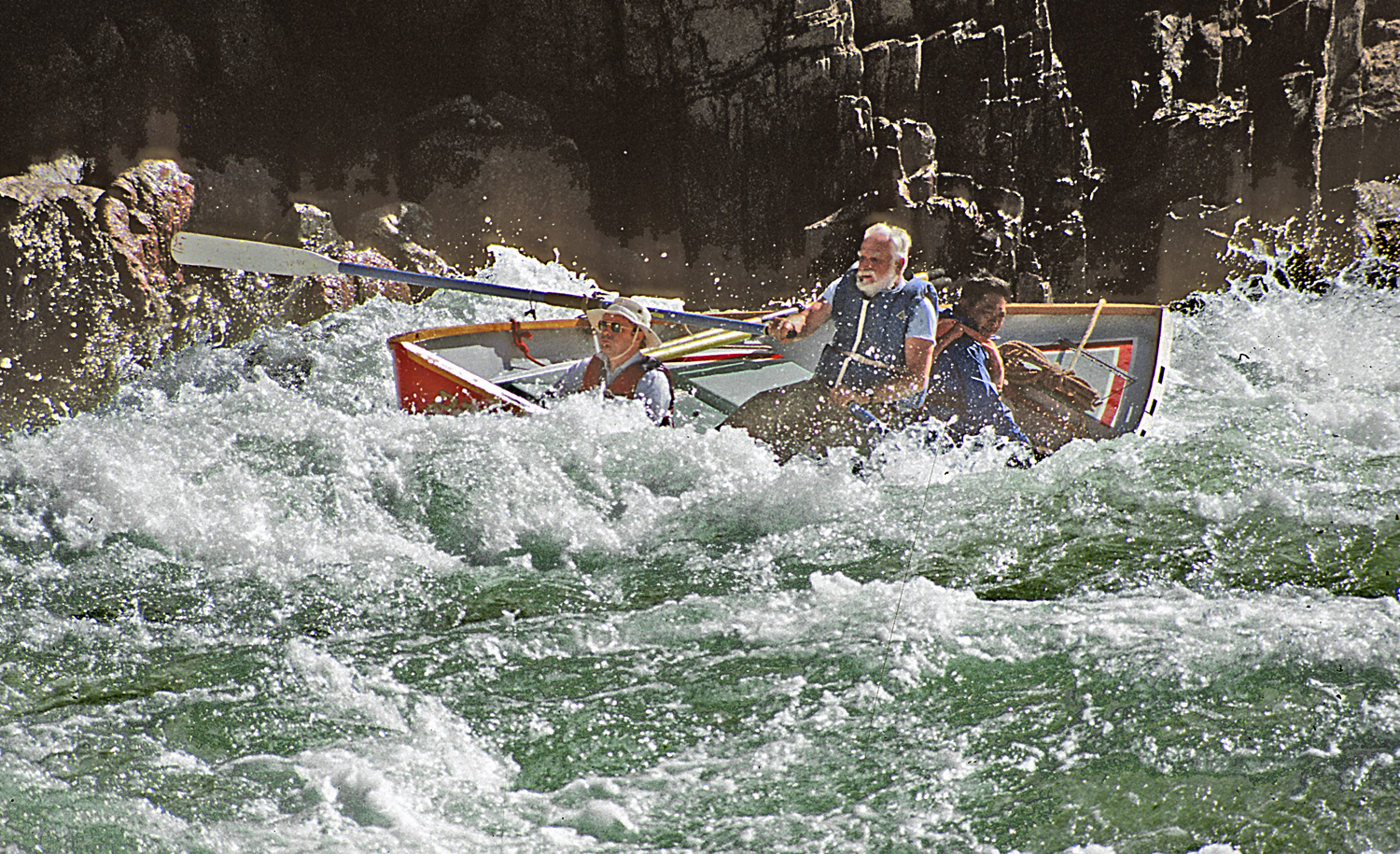 Martin Litton rowing a dory in the Grand Canyon