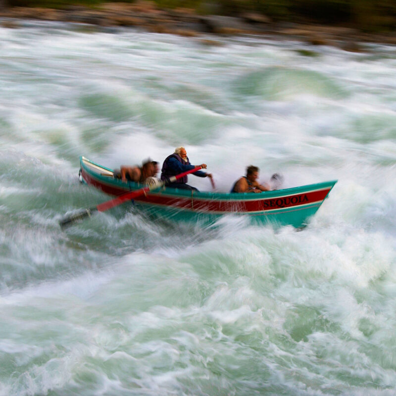 Martin Litton rowing a dory in the Grand Canyon