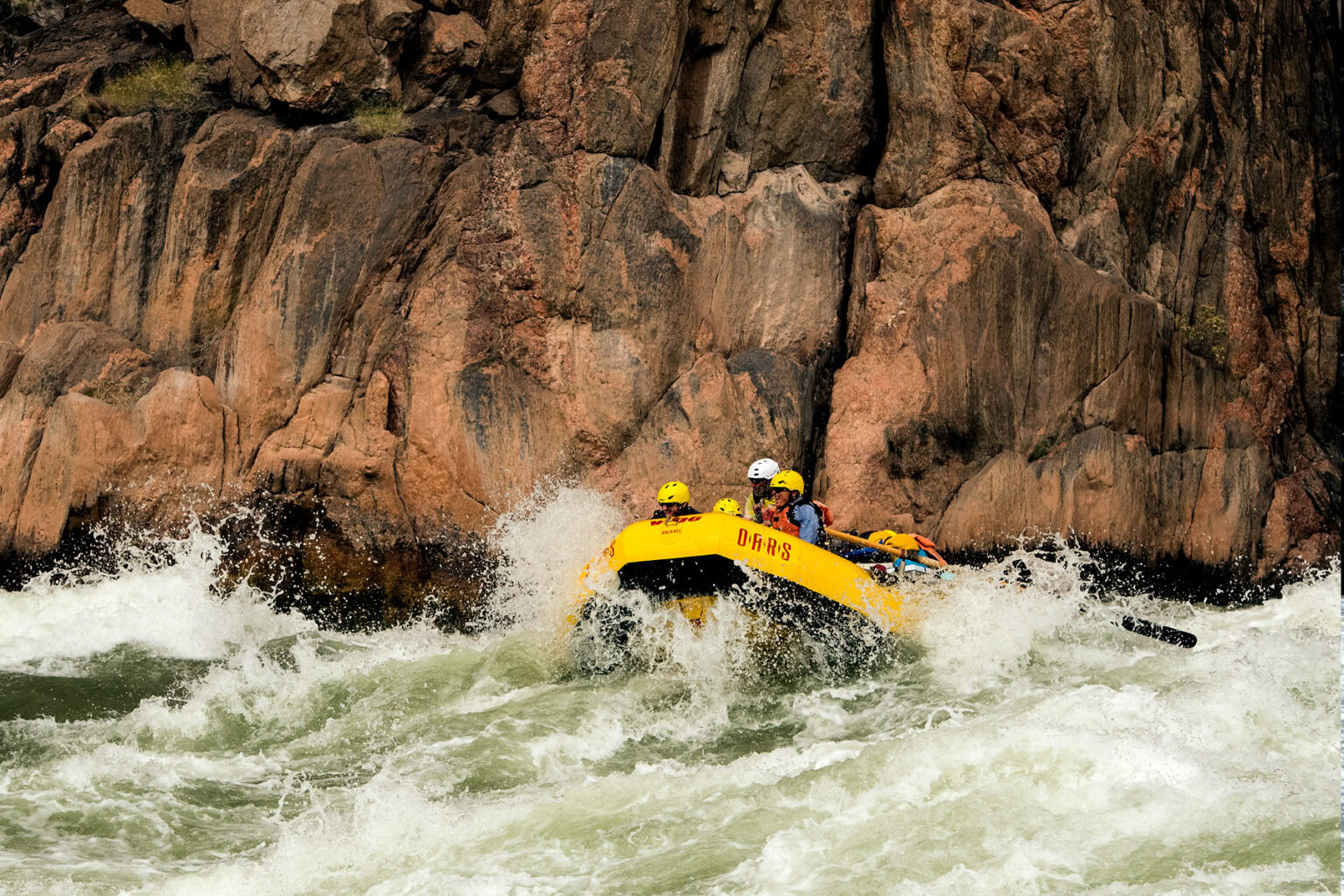 Yellow OARS raft in whitewater in Grand Canyon