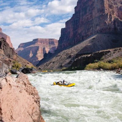 OARS baggage raft drops into Lava Falls with two other rafts wait their turn