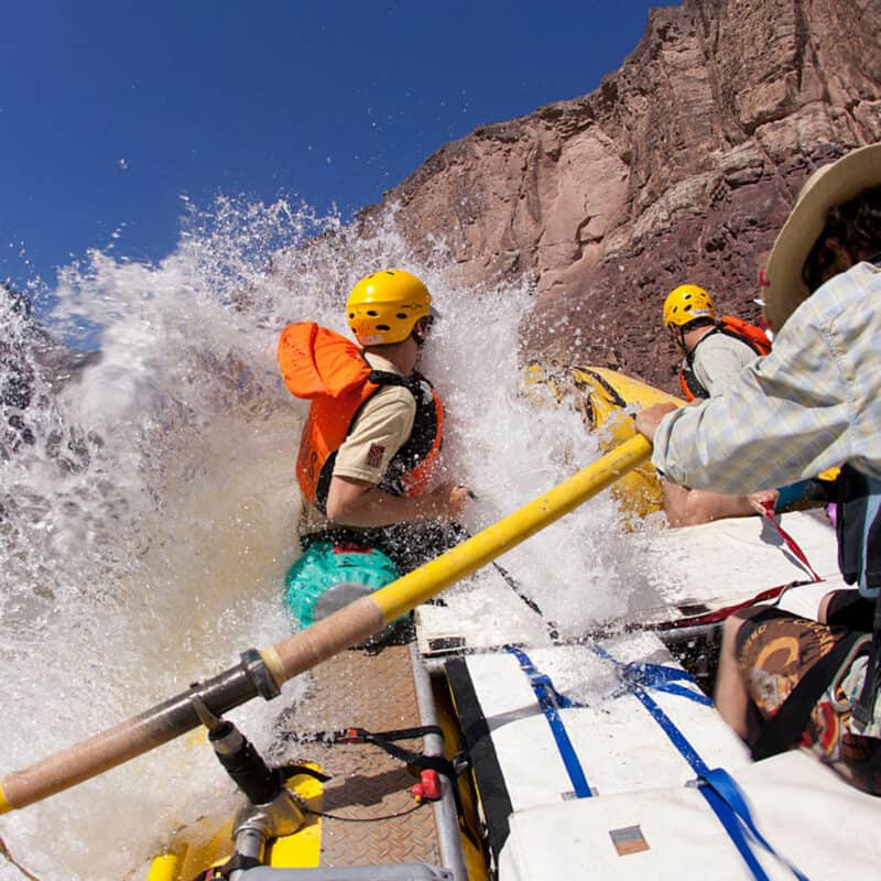 People rafting down the Grand Canyon rapids.