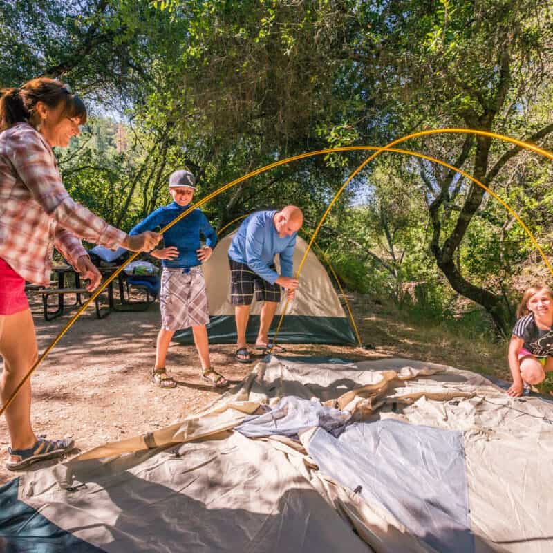 Family setting up a tent.