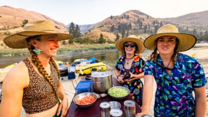 Three female river guides in big hats with big smiles