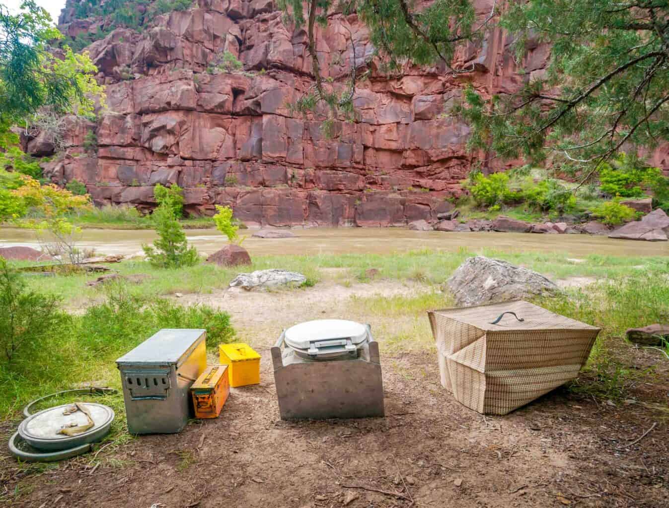 portable toilet sitting outside next to a river.