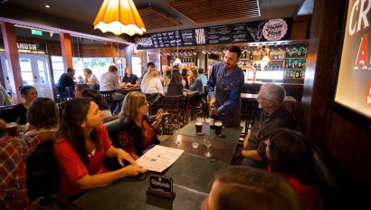 A group enjoys happy hour at a Patagonian pub